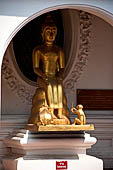 Thailand, Phra Pathom Chedi, the nation's largest pagoda in Nakorn Pathom. Buddha statue in niche of the outer courtyard.